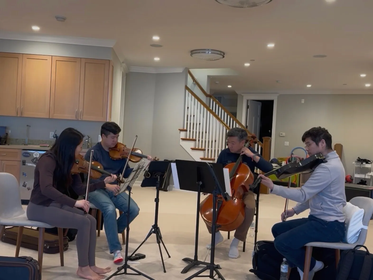 Tell Quartet rehearsing together with strings and music stands